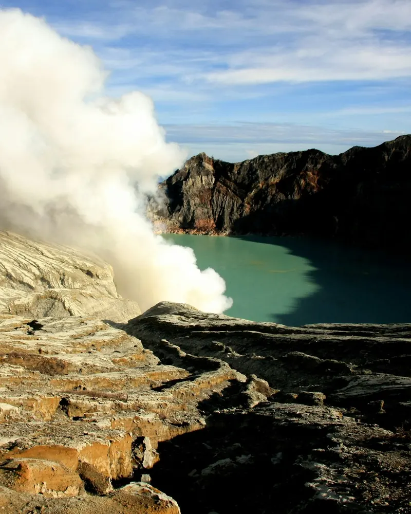 Clouds of steam and mist rolling over the Ijen crater walls