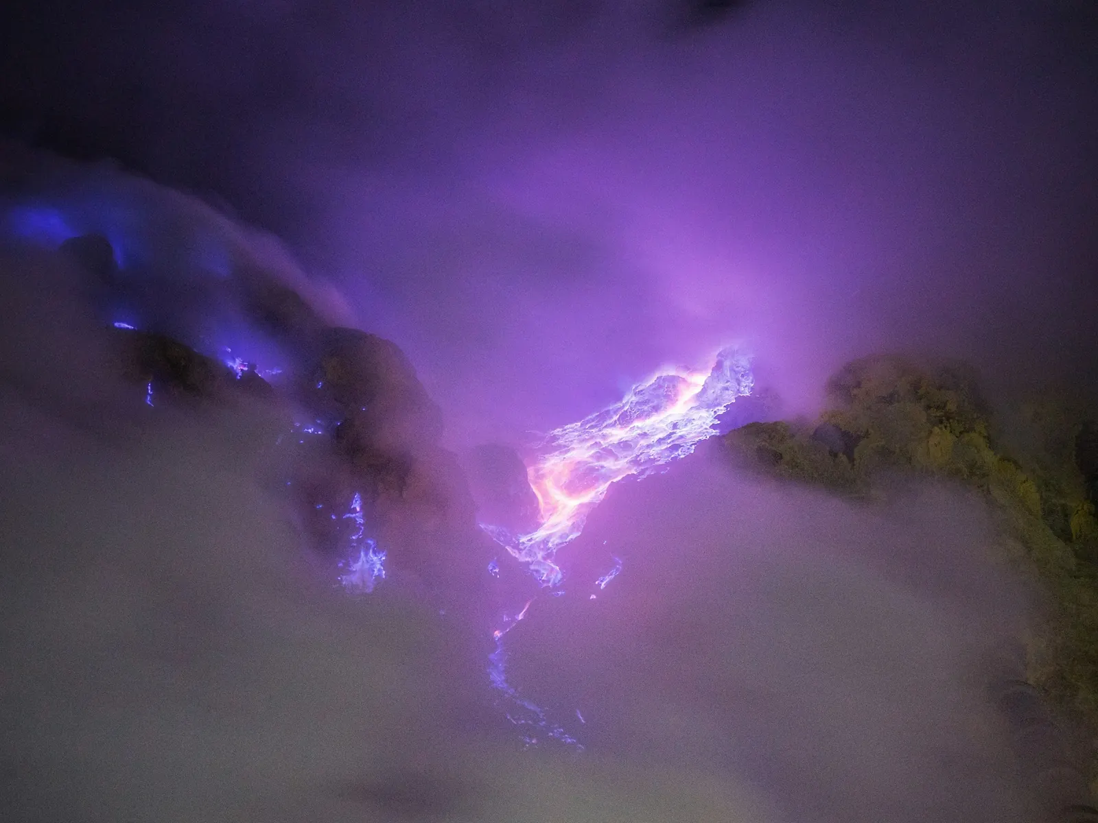 Blue fire of burning sulfuric gas inside the Kawah Ijen crater at night