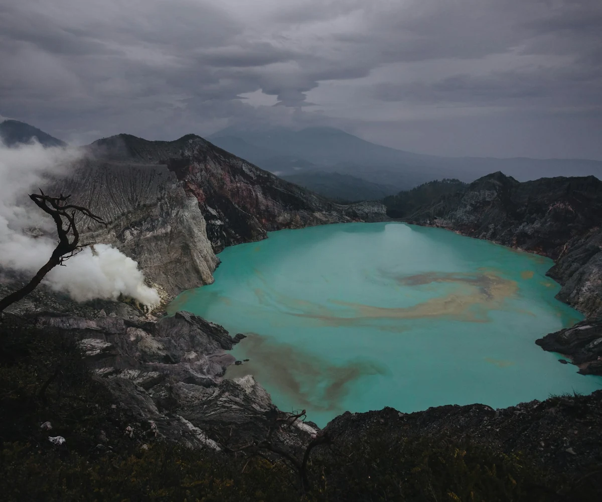 Clouds drifting over the rim of the Kawah Ijen crater lake