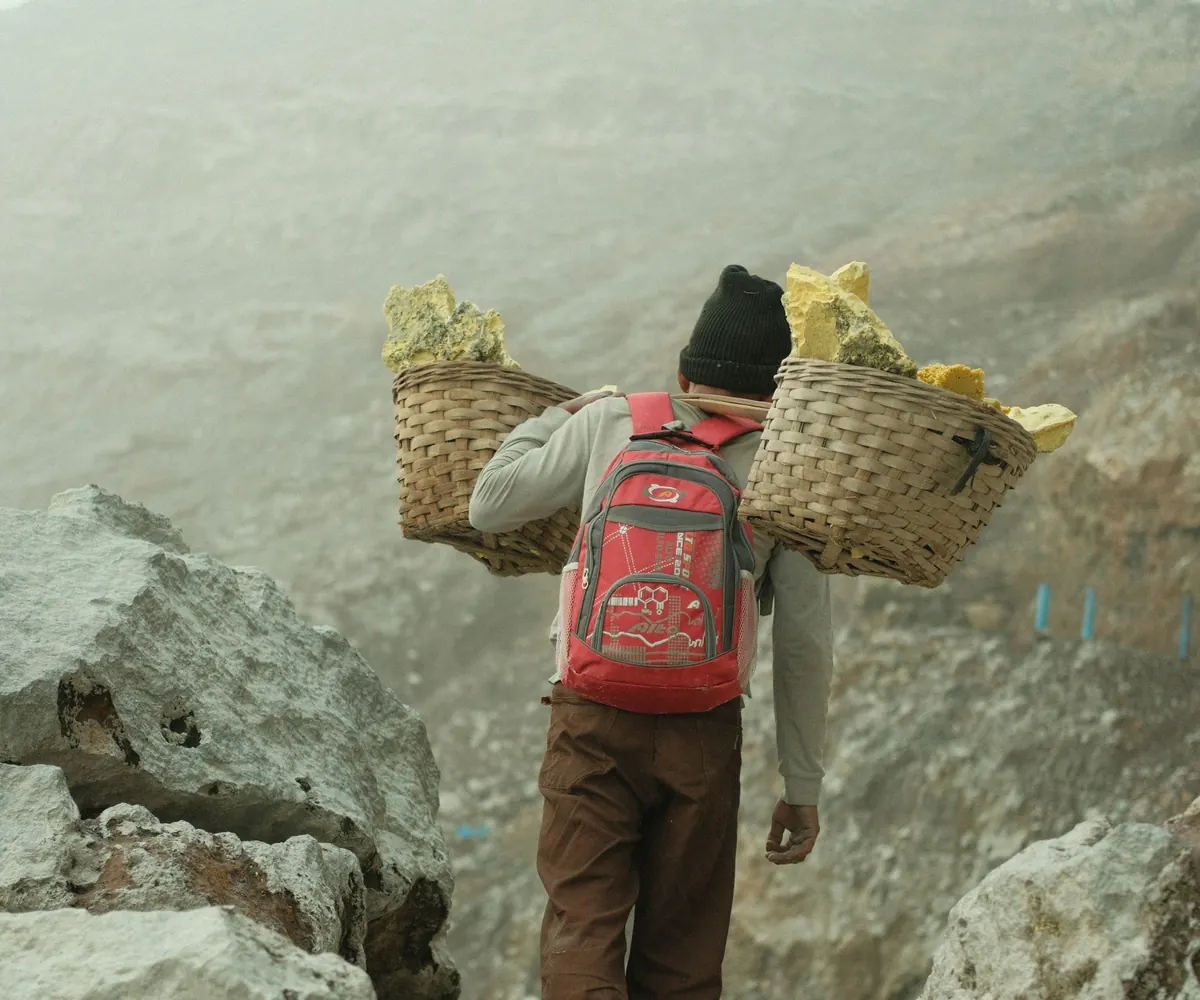 Sulfur miner carrying baskets on the Ijen crater path